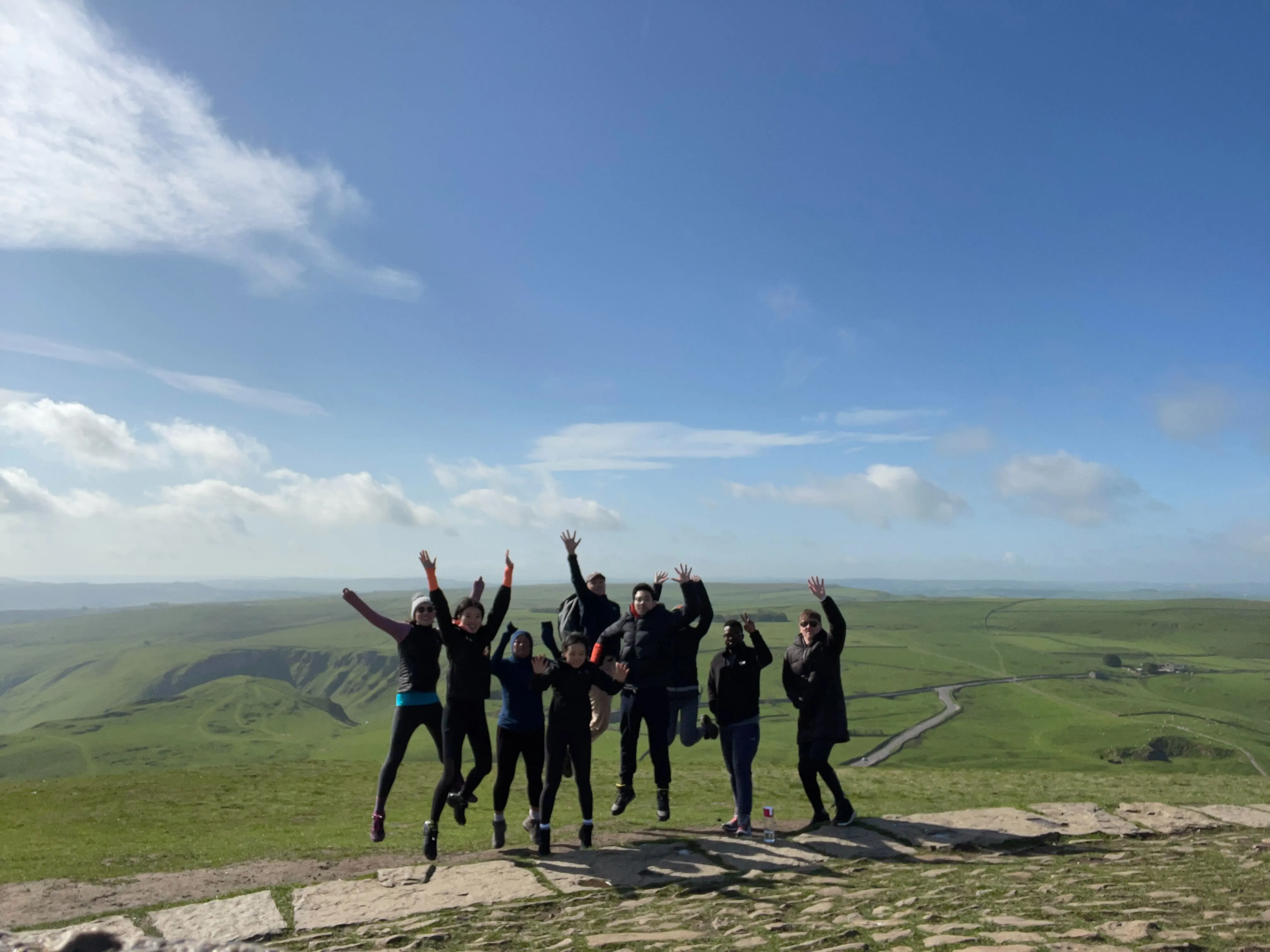 Sourceful team on a hike in the Peak District, jumping in the air